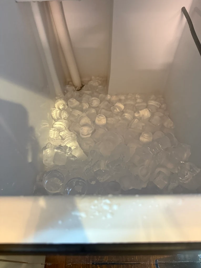 Technician repairing ice maker tray inside freezer – BozmanFix Appliance Repair Atlanta GA