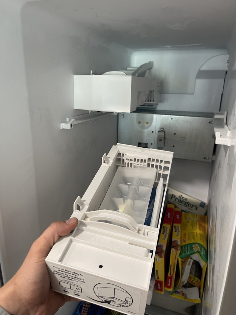 Professional ice maker repair Wesley Chapel - technician diagnosing and replacing ice maker components in refrigerator