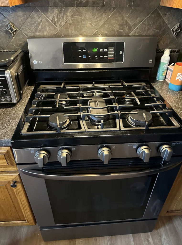 Oven repair Wesley Chapel FL — technician testing oven igniter current draw and temperature sensor resistance