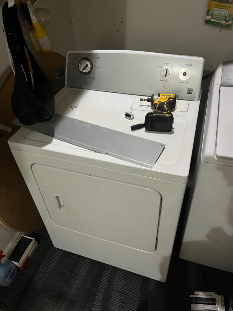 Dryer repair in Wesley Chapel FL - technician servicing electric dryer with thermal fuse and heating element replacement tools