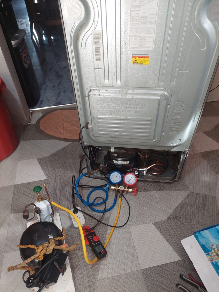 LG refrigerator compressor replacement in progress — Bozmanfix technician