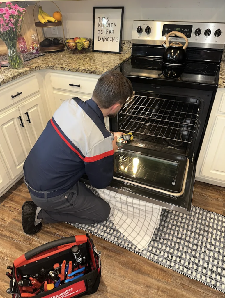 Bozmanfix appliance repair technician servicing a kitchen appliance in Atlanta